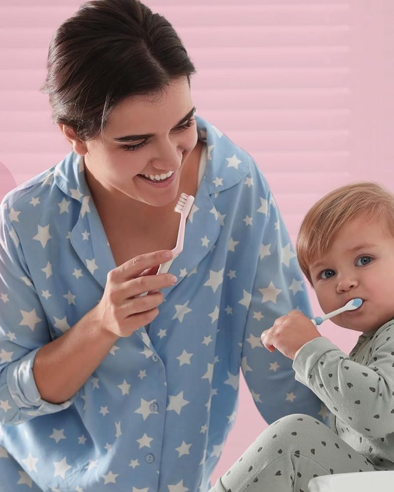 A parent and toddler brushing together